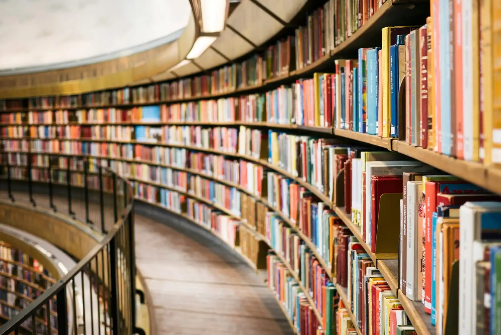 Books arranged on a wooden shelf